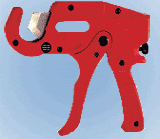 A red pipe cutter is sitting on the ground.