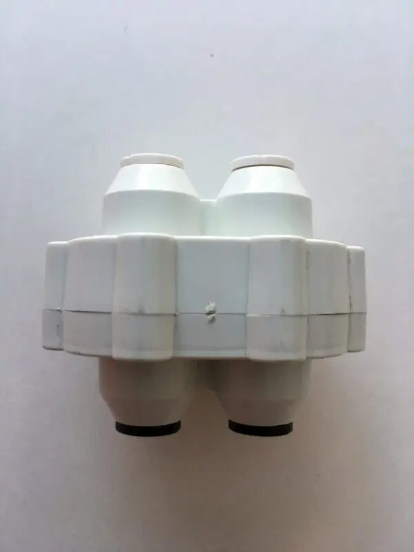 A white plastic bottle with two valves on top of it.